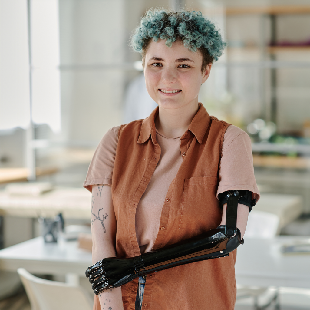 young-girl-with-prosthetic-arm-smiling-camera-doctors-office